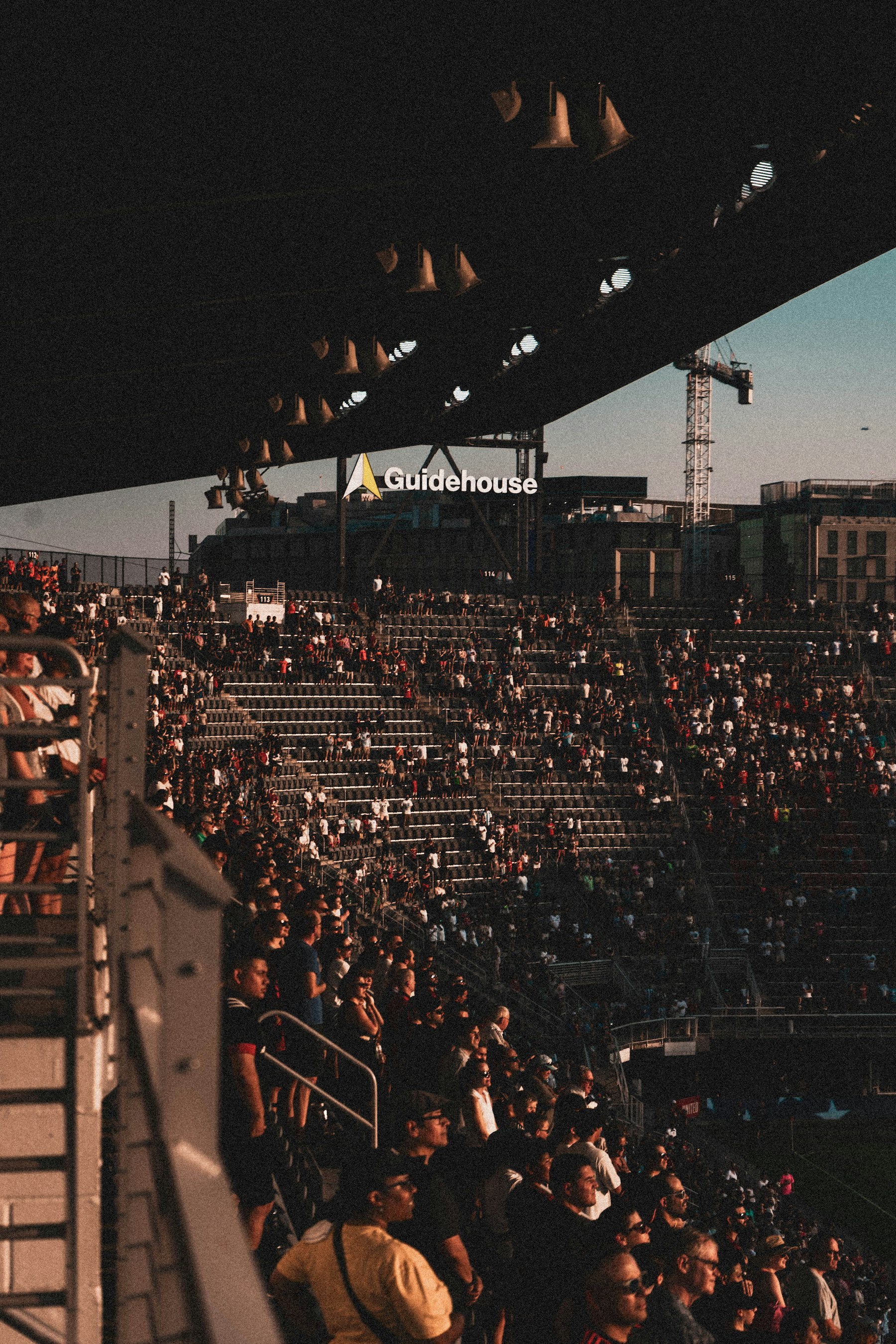 Soccer player battling for the ball under stadium lights